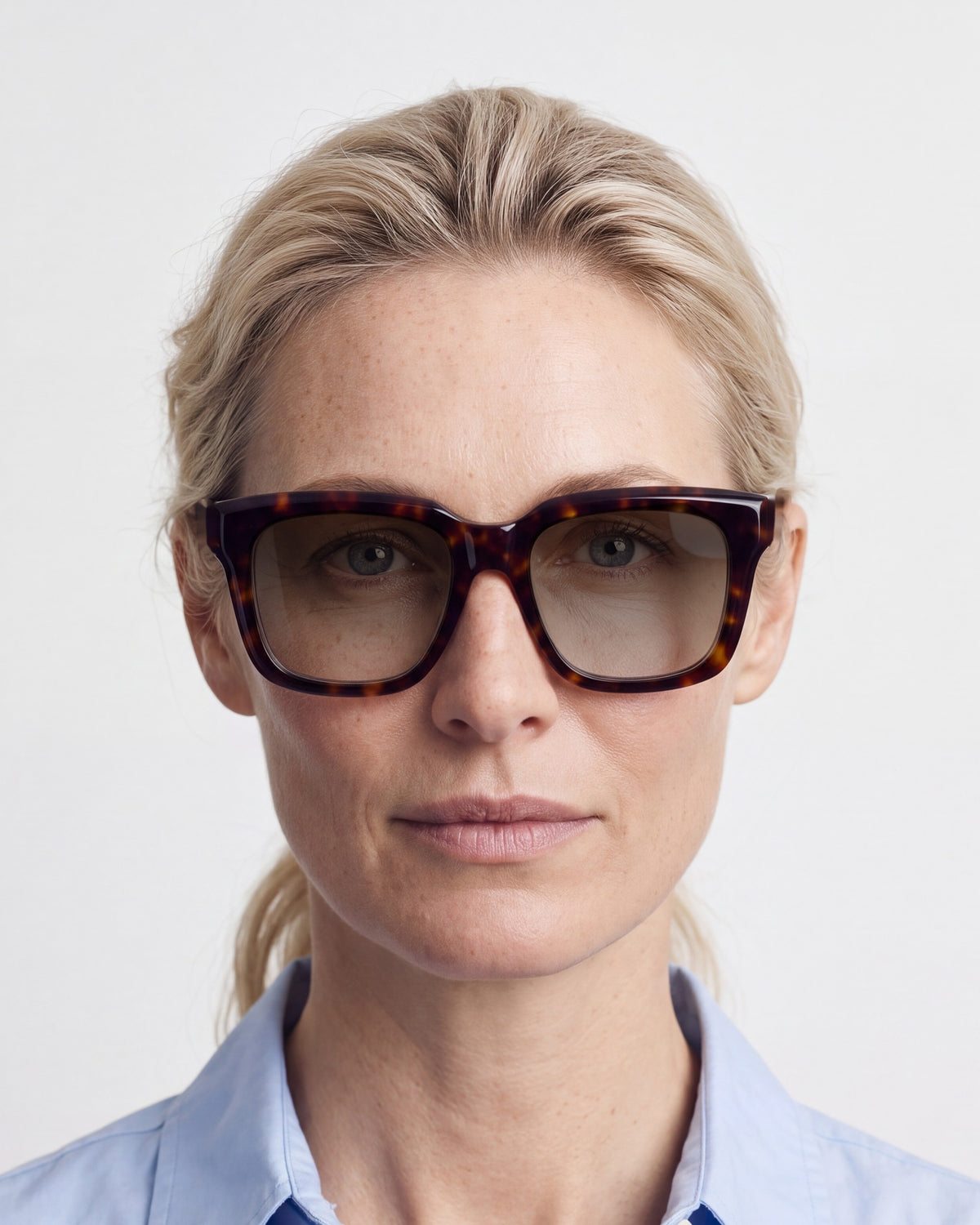 Therese in tortoiseshell, worn, sun lenses